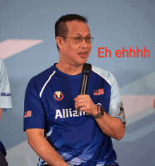 a man wearing a blue shirt that says allian on it