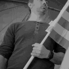 a man holding a flag with a tag on it that says " daily "