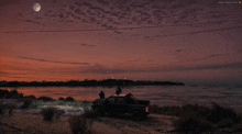 a truck is parked on the beach at sunset with a full moon in the sky