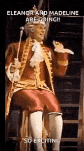 a man in a costume is sitting on a stool with a cane and a crown on his head .