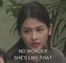 a woman says " no wonder she 's like that " in front of a green curtain