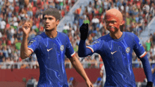 two soccer players wearing blue jerseys with the chelsea logo on them