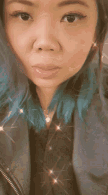 a woman with blue hair is wearing a jacket