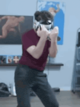 a man wearing a virtual reality headset is dancing in a living room .