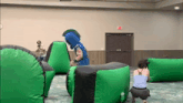 a woman is taking a picture of a spartan mascot in a room
