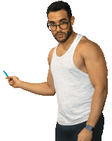 a man wearing glasses and a white tank top holds a pen