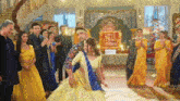a man and a woman are dancing in front of a group of people