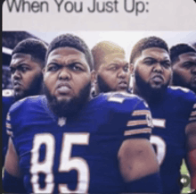 a group of football players standing next to each other with the number 85 on their jersey