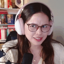 a woman wearing headphones and glasses is making a face