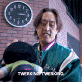 a man in a deus jacket holding a stuffed animal