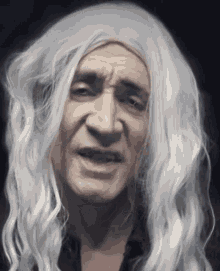 a man with long white hair and a black shirt is making a funny face