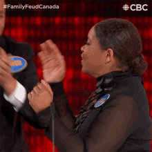 a man and a woman are on a family feud canada show
