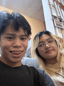 a boy and a girl are posing for a picture and the girl is wearing a shirt that says " i love you "