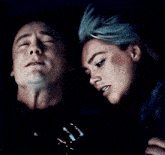 a man and woman are looking at each other in the dark