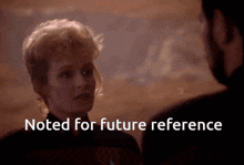 a man and a woman looking at each other with the words noted for future reference