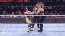 two women are wrestling in a ring with a referee in front of a crowd and the hashtag #wweraw is on the screen