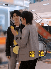 two men are standing next to each other with chinese characters on their jackets