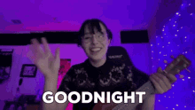 a woman is playing a ukulele and saying goodnight