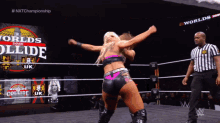 two women wrestling in a ring with the words worlds collide uk on the screen