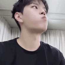 a young man making a funny face with his mouth open