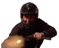 a man wearing a helmet is holding a gun in his right hand