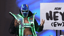 a wrestler stands in front of a sign that says hey crew