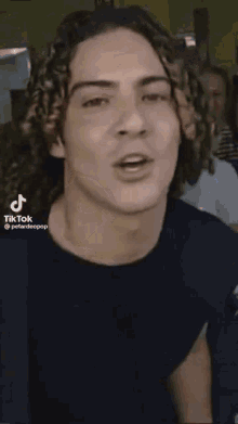 a tiktok video of a man with long hair and a red hat