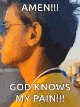 a young boy wearing sunglasses and a yellow shirt says amen !!! god knows my pain !!!