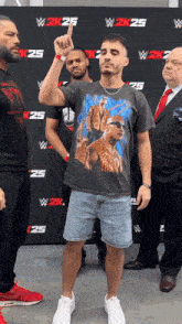 a man stands in front of a wall that says w2k25 on it
