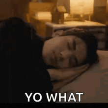 a man is sleeping on a bed with his eyes closed and the words yo what written on the bottom .