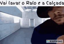 a man in a hat is standing in an empty room with the caption vai lavar o raio e a calcada