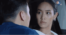 a man and a woman are looking at each other with the number 7 on the bottom