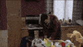 a man is standing in a kitchen with a stove that says 000