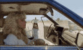 a woman is sitting in a car with a glass of wine in her hand