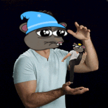 a man wearing a blue hat holds a cartoon character in his hands