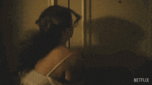 a person is opening a door with a netflix advertisement in the background