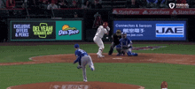 a baseball game is being played in front of a del taco ad