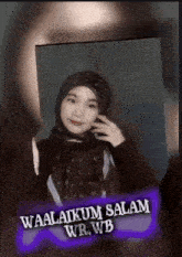 a woman wearing a hijab with the words waalaikum salam wr.wb on the bottom