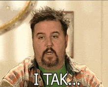 a man with a beard says " i tak " in white letters