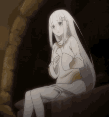 a girl with long white hair is sitting on a bed
