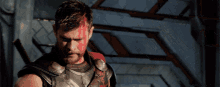 a man with red paint on his face and a sword in his hand