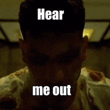 a close up of a man 's face with blood on it and the words `` hear me out '' .