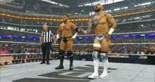 two wrestlers are standing in a wrestling ring with a sign that says the most wanted on it