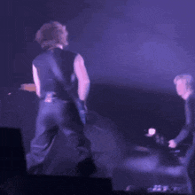 a blurry image of a person playing a guitar on stage