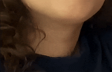 a close up of a person 's neck with a dark background