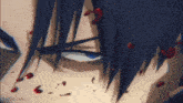 a close up of a man 's face with blood coming out of it .