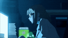 a girl with glasses is sitting in front of a computer monitor