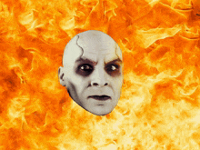 a man 's head is surrounded by flames and looks scared