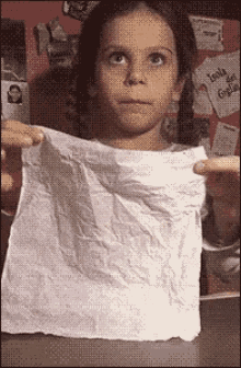 a girl is holding a piece of paper that says isola