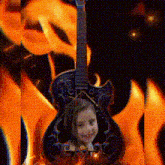 a little girl is sitting on a guitar in front of flames